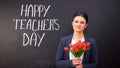 Happy teachers day written on blackboard, smiling lady with tulips standing near Royalty Free Stock Photo