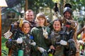 Happy team of five paintball players outdoors