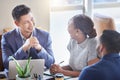 A happy team makes a productive team. a group of colleagues having a meeting in a boardroom at work. Royalty Free Stock Photo