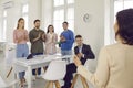 Happy employees clap hands applaud greeting smiling successful female coach presenter at meeting, diverse worker give Royalty Free Stock Photo