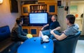 Happy team of ship officers watch TV onboard of vessel Royalty Free Stock Photo