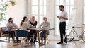 Happy teammates listening to trainer at workshop. Royalty Free Stock Photo