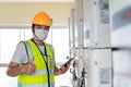 Happy technician checking controller solar energy of the solar panels Royalty Free Stock Photo