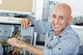 happy it technician repairing broken pc desktop computer Royalty Free Stock Photo
