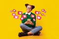 Happy teen african american female in glasses has romantic chat with hearts on phone, enjoys message