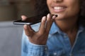 Happy teen African girl giving voice commands to virtual assistant Royalty Free Stock Photo