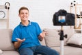 Teen blogger greeting his viewers while recording video