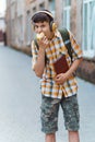 Happy teen boy portrait on the way to school, he is eating an apple, education and back to school concept Royalty Free Stock Photo