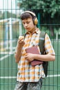 Happy teen boy portrait on the way to school, he is eating an apple, education and back to school concept Royalty Free Stock Photo