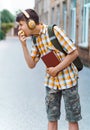 Happy teen boy portrait on the way to school, he is eating an apple, education and back to school concept Royalty Free Stock Photo