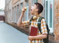 Happy teen boy portrait on the way to school, he is eating an apple, education and back to school concept Royalty Free Stock Photo