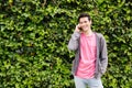 Happy teen boy smiles while talking by phone Royalty Free Stock Photo