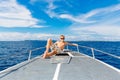 Happy teen boy in sunglasses on the yacht. Tropical sea in the b