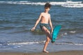 Happy teen boy in the swim flippers having fun on the sand ÃÂ¾n the beach Royalty Free Stock Photo