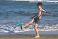 Happy teen boy in the swim flippers having fun on the sand ÃÂ¾n the beach Royalty Free Stock Photo