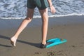 Happy teen boy in the swim flippers having fun on the sand ÃÂ¾n the beach Royalty Free Stock Photo