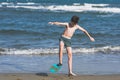 Happy teen boy in the swim flippers having fun on the sand ÃÂ¾n the beach Royalty Free Stock Photo