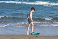 Happy teen boy in the swim flippers having fun on the sand ÃÂ¾n the beach Royalty Free Stock Photo