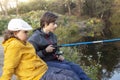 Happy teen boys go fishing on the river, children of the fisherm Royalty Free Stock Photo