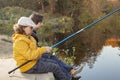 Happy teen boys go fishing on the river, two children of the fisherman with a fishing rod on the shore of the river Royalty Free Stock Photo