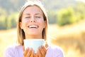 Happy teen breathing fresh air holding coffee cup