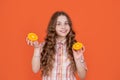 happy teen child hold citric fruit on orange background