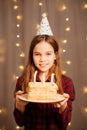 Happy teen girl with birthday cake. tradition to make wish and blow out fire Royalty Free Stock Photo