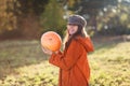 Happy teen girl carries an orange pumpkin in her hands Royalty Free Stock Photo