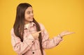 happy teen girl in shirt. hipster kid casual style. tween child in plaid shirt presenting product.