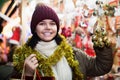 Happy teen girl choosing gifts at festive fair