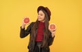 happy teen girl in hat and leather jacket hold cut grapefruit, vitamin