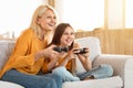 Happy teen girl having fun with her grandmother at home Royalty Free Stock Photo