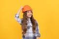 happy teen girl in helmet and checkered shirt, build