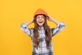 happy teen girl in helmet and checkered shirt, carpenter