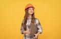 happy teen girl in helmet and checkered shirt holding computer, future career Royalty Free Stock Photo