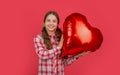 happy teen girl hold love heart balloon on red background Royalty Free Stock Photo