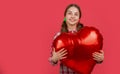 happy teen girl hold love heart balloon on red background. copy space Royalty Free Stock Photo