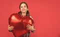 happy teen girl hold love heart balloon on red background. copy space Royalty Free Stock Photo