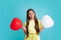 Happy teen girl hold red heart party balloon for valentines day, love symbol, be my valentine. Happy kids face, positive Royalty Free Stock Photo