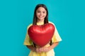 Happy teen girl hold red heart party balloon for valentines day, love symbol, be my valentine. Happy kids face, positive Royalty Free Stock Photo