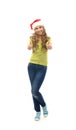 A happy teen girl holding thumbs up in a Christmas hat Royalty Free Stock Photo