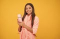 happy teen girl in home terry bathrobe with thermos bottle, morning Royalty Free Stock Photo