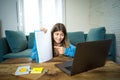 Teenage girl on laptop studying online at home as high school is closed due to new COVID-19 Lockdown Royalty Free Stock Photo