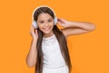 happy teen girl listening music in headphones on yellow background Royalty Free Stock Photo