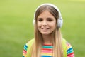 Happy teen girl listening to music in headphones outdoors, school Royalty Free Stock Photo