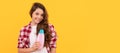 happy teen girl with long curly hair hold shampoo bottle, cosmetic. Banner of child girl hair care, studio poster header