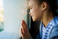 Happy teen girl look out of window outside. recovered. Royalty Free Stock Photo