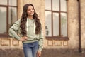 Happy teen girl model posing in casual fashion style blurry outdoors, copy space Royalty Free Stock Photo