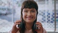 Happy teen girl posing in headphones closeup. Smiling stylish teenager enjoying Royalty Free Stock Photo