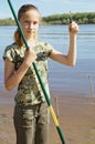 Happy teen girl preparing to fishing on the river Royalty Free Stock Photo